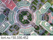 Aerial top view of geometric structure of new high rise condominium buildings with green lawns and developed infrastructure. Contemporary residential district architecture. Стоковое фото, агентство Ingram Publishing / Фотобанк Лори