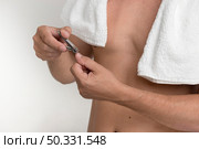 man cutting finger nails nail clipper against white background. High resolution photo. man cutting finger nails nail clipper against white background. High quality photo. Стоковое фото, агентство Ingram Publishing / Фотобанк Лори