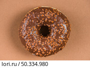 dark chocolate doughnut with sprinkles brown background. Стоковое фото, агентство Ingram Publishing / Фотобанк Лори