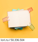colorful ladders leaning opened notebook. Стоковое фото, агентство Ingram Publishing / Фотобанк Лори