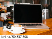 frontview laptop coffee wooden surface. Стоковое фото, агентство Ingram Publishing / Фотобанк Лори