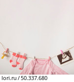 pacifier sonography picture socks baby clothing hanging clothesline white background. Стоковое фото, агентство Ingram Publishing / Фотобанк Лори