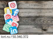 paper cut outs applications icons old wooden background. Стоковое фото, агентство Ingram Publishing / Фотобанк Лори