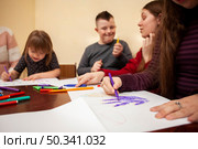 children with down syndrome drawing having fun. Стоковое фото, агентство Ingram Publishing / Фотобанк Лори