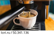 coffee with frothing pouring from espresso machine. Стоковое фото, агентство Ingram Publishing / Фотобанк Лори