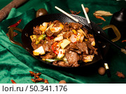 Savory Sizzling Beef Dish Displayed in a Black Bowl at a Chinese Restaurant. Стоковое фото, фотограф Aleksandr Golubev / Фотобанк Лори