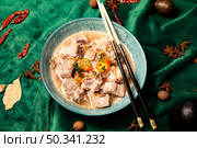 Pork Ribs Soup Served With Chopsticks on a Green Velvet Tablecloth. Стоковое фото, фотограф Aleksandr Golubev / Фотобанк Лори