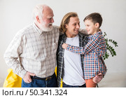family men different generations hugging together. Стоковое фото, агентство Ingram Publishing / Фотобанк Лори