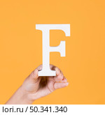 female hand holding up uppercase capital letter f. Стоковое фото, агентство Ingram Publishing / Фотобанк Лори