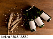 beer bottles white label with wheat spike wooden table. Стоковое фото, агентство Ingram Publishing / Фотобанк Лори
