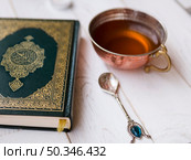 OLYMPUS DIGITAL CAMERA. top view arrangement with quran tea spoon. Редакционное фото, агентство Ingram Publishing / Фотобанк Лори