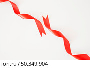 curled red ribbons white background. Стоковое фото, агентство Ingram Publishing / Фотобанк Лори