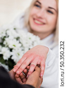 man placing diamond engagement ring finger his fiancee. Стоковое фото, агентство Ingram Publishing / Фотобанк Лори