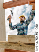 construction worker with hammer hard hat building roof house. Стоковое фото, агентство Ingram Publishing / Фотобанк Лори