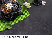 dried tea herb white jasmine flower black background. Стоковое фото, агентство Ingram Publishing / Фотобанк Лори