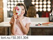 girl sitting backstage holding venetian mask front her face. Стоковое фото, агентство Ingram Publishing / Фотобанк Лори
