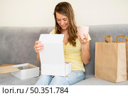 portrait woman unboxing products ordered. Стоковое фото, агентство Ingram Publishing / Фотобанк Лори