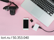 laptop with camera sd card pink table. Стоковое фото, агентство Ingram Publishing / Фотобанк Лори