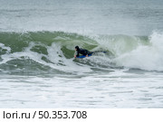 Bodyboarder performing a tube trick surfing ocean wavesurfing ocean wave on a cloudy winter day. Стоковое фото, агентство Ingram Publishing / Фотобанк Лори