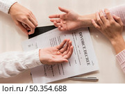 hands with divorce decree close up. Стоковое фото, агентство Ingram Publishing / Фотобанк Лори