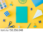 developing child accessories laying around notepad. Стоковое фото, агентство Ingram Publishing / Фотобанк Лори