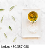 rosemary garlic cloves oil bowl with salt white tray. Стоковое фото, агентство Ingram Publishing / Фотобанк Лори