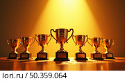 Vibrant digital illustration of gleaming golden trophies and awards on wooden surface with dramatic lighting. Стоковое AI-изображение, AI-художник Андрей Бакусов / Фотобанк Лори