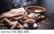 herbal tea with pinecone teapot sack button wicker basket ball yarn table. Стоковое фото, агентство Ingram Publishing / Фотобанк Лори