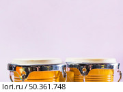 bongo drum pink background. Стоковое фото, агентство Ingram Publishing / Фотобанк Лори