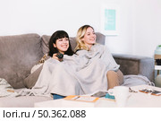 cuddling girl enjoying funny movie. Стоковое фото, агентство Ingram Publishing / Фотобанк Лори