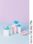many colorful paper shopping bags blue surface. Стоковое фото, агентство Ingram Publishing / Фотобанк Лори