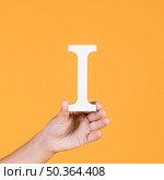 female hand holding up capital alphabet i. Стоковое фото, агентство Ingram Publishing / Фотобанк Лори