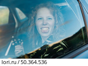 funny young woman fooling around car. Стоковое фото, агентство Ingram Publishing / Фотобанк Лори