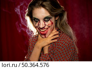 halloween female model choking with her own hands shooting. Стоковое фото, агентство Ingram Publishing / Фотобанк Лори