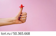 OLYMPUS DIGITAL CAMERA. close up red condom thumb. Стоковое фото, агентство Ingram Publishing / Фотобанк Лори
