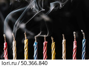 row extinguished candles arranged black background. Стоковое фото, агентство Ingram Publishing / Фотобанк Лори