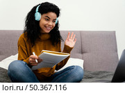 teenage girl using laptop headphones online school. Стоковое фото, агентство Ingram Publishing / Фотобанк Лори