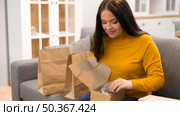 woman unboxing her new purchase. Стоковое фото, агентство Ingram Publishing / Фотобанк Лори