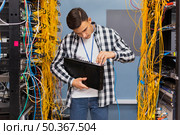 young network engineer holding ethernet switches. Стоковое фото, агентство Ingram Publishing / Фотобанк Лори