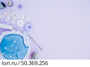 sewing items with pincushion thimble needle spool button purple backdrop. Стоковое фото, агентство Ingram Publishing / Фотобанк Лори