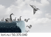 Adapt to survive concept as paper swans falling off a waterfall and one origami bird adapting new skills and flying away to safety. Стоковое фото, агентство Ingram Publishing / Фотобанк Лори