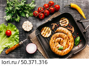 grilled snail sausages pan with spices vegetable wooden grey backdrop. Стоковое фото, агентство Ingram Publishing / Фотобанк Лори