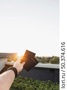 person showing passports sunset. Стоковое фото, агентство Ingram Publishing / Фотобанк Лори