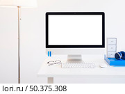 OLYMPUS DIGITAL CAMERA. workplace with keyboard near monitor eyeglasses headphones near lamp. Стоковое фото, агентство Ingram Publishing / Фотобанк Лори
