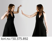 Concept about two womens disputing something - isolated on Grey. Стоковое фото, агентство Ingram Publishing / Фотобанк Лори