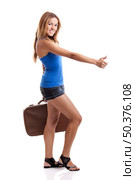 Beautiful young woman hitch hiking with old leather suitcase, isolated on white. Стоковое фото, агентство Ingram Publishing / Фотобанк Лори