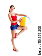 Beautiful young woman posing with a beach ball. Стоковое фото, агентство Ingram Publishing / Фотобанк Лори