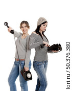 Two young women talking with old telephones - Isolated on white. Стоковое фото, агентство Ingram Publishing / Фотобанк Лори