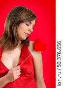 Beautiful woman with a heart on the hands (Red background created on PS) Стоковое фото, агентство Ingram Publishing / Фотобанк Лори