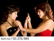 Two young beautiful sisters giving the hands and having fun - This models are true twins. Стоковое фото, агентство Ingram Publishing / Фотобанк Лори